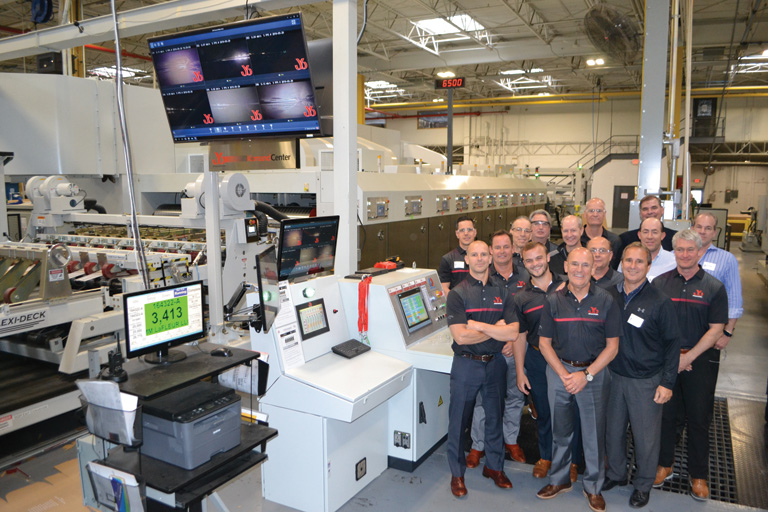 JB Machinery Sales Team pose by JB equipped Abbott-Action diecutter